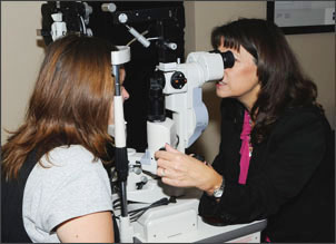 Dr. Carole giving an eye exam